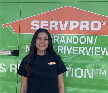 Employee in front of service truck