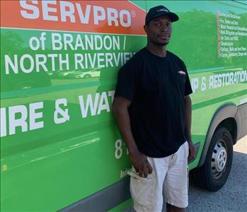 SERVPRO technician standing in front of service truck